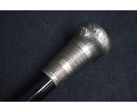 A George V silver mounted walking stick, the pommel having engine turned decoration to the ebonised cane, marks for London 19