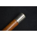 A Victorian silver mounted walking stick, the pommel of plain design, marks for London 1887,