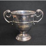 An early Edwardian silver trophy, of traditional form having opposing scroll handles, with
