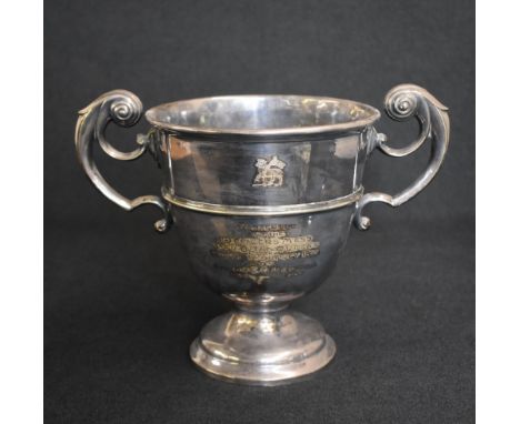 An early Edwardian silver trophy, of traditional form having opposing scroll handles, with personalised inscription to both s