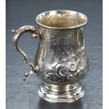 A Victorian silver tankard, of traditional bulbous form having a slightly flared rim, scroll handle,