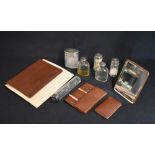 An early 20th century cased travelling set, the brown leather case with protective cover