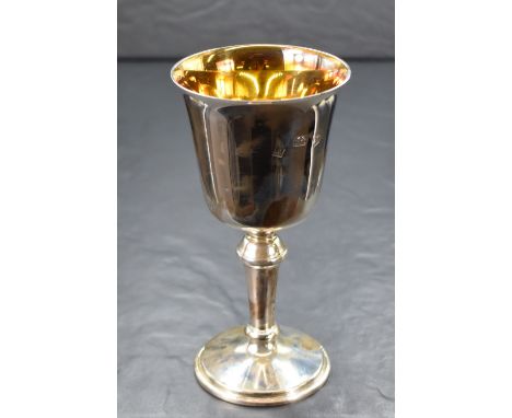 A cased Elizabeth II silver cup, of traditional form having a slightly flared rim, gilted interior raised on a knopped stem a
