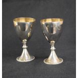 A pair of Elizabeth II silver goblets, of traditional form with gilt interior raised on a knopped