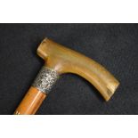 A Victorian silver mounted walking stick, the wooden cane with curved horn handle, having decorative