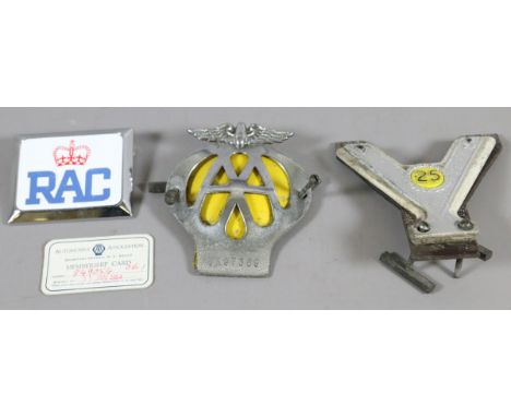A lot of vintage car badges including AA, RAC along with an AA membership car.