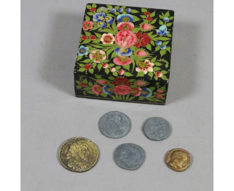 A lacquered trinket box containing five souvenir coins after Roman originals.