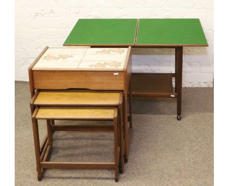 A tile top teak nest of three coffee tables with single drawer along with a teak folding top card table.