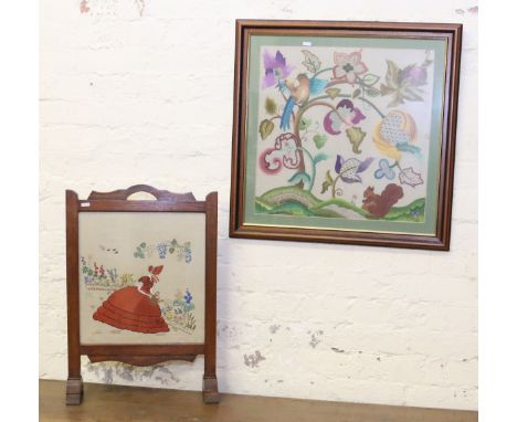 An oak embroidered fire screen along with a framed silk work picture.