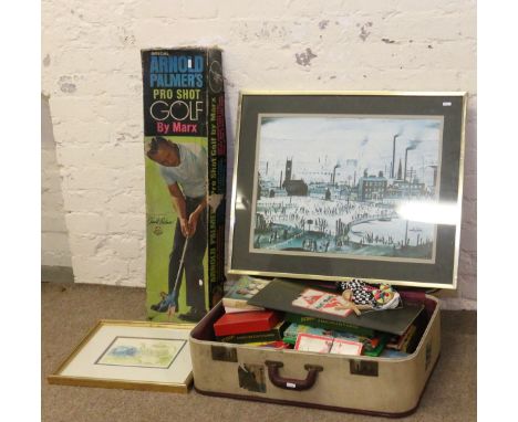 A suitcase and contents of childrens games along with a boxed Arnold Palmer pro-shot golf set by Marx  and two framed prints.