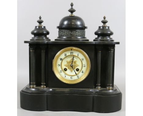 A Victorian slate mantel clock of classical form and housing a French eight day movement striking half hourly on a gong.