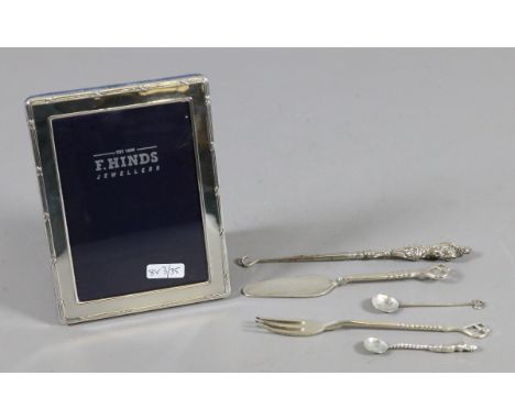 A silver photograph frame silver button hook, conserve spoons, pickle fork and butter knife.