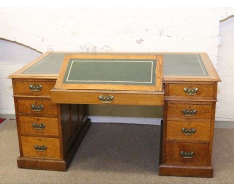 A Victorian light oak twin pedestal desk with leather inset top and having two draughtsmens slides.