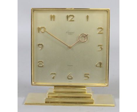 An Art Deco Rosemount Geneve brass cased eight day mantel clock with satin dial, applied Arabic numeral markers and raised on