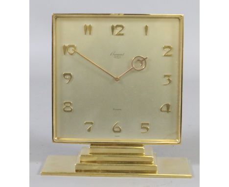 An Art Deco Rosemount Geneve brass cased eight day mantel clock with satin dial, applied Arabic numeral markers and raised on