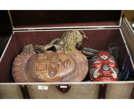 A leather bound trunk containing assorted African ceremonial masks.