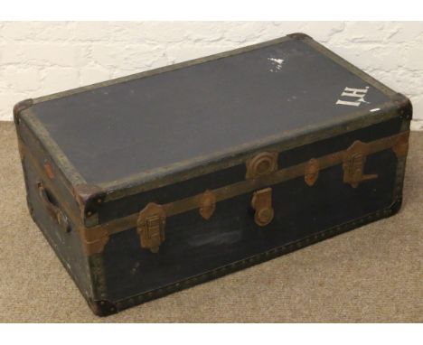 A metal bound travel trunk with interior lining.