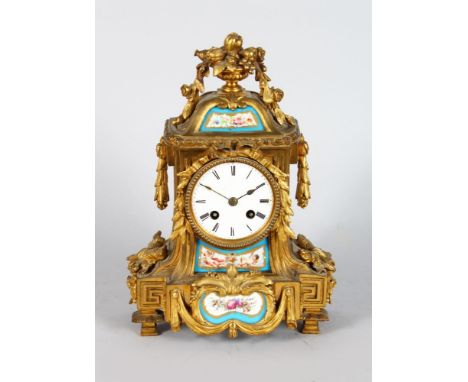 A 19TH CENTURY LOUIS XVI STYLE ORMOLU CLOCK, with painted Serves style panels, circular dial, urn finial and swags 12in high