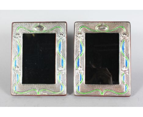 A PAIR OF SILVER AND ENAMEL PHOTOGRAPH FRAMES 7in high x 6in wide