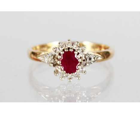 AN 18ct GOLD RUBY AND DIAMOND CLUSTER RING