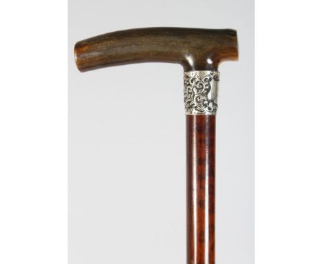 A WALKING STICK WITH RHINO HANDLE, silver band engraved H. M. Hemingway