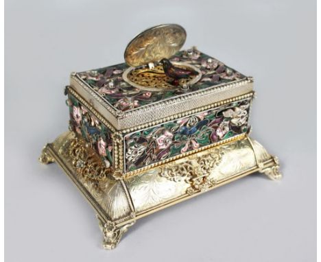 A SUPERB 19TH CENTURY GERMAN SILVER AND ENAMEL TABLE SINGING BIRD MUSICAL BOX, with oval enamel flip up top revealing a singi