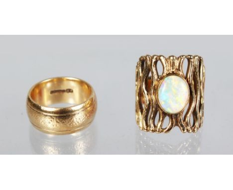 A 9ct GOLD WEDDING BAND AND A PIERCED GOLD RING, set with an opal