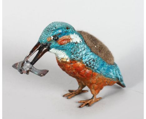 A COLD PAINTED KINGFISHER PIN CUSHION, with a fish in it's mouth, 3.5in high