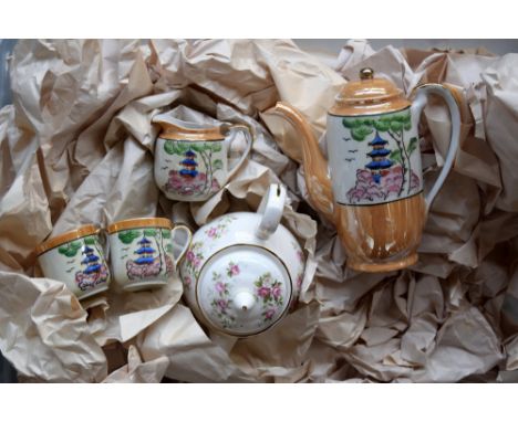A collection of ceramic tea service pieces, mostly cups and saucers, including Klimax Japanese porcelain