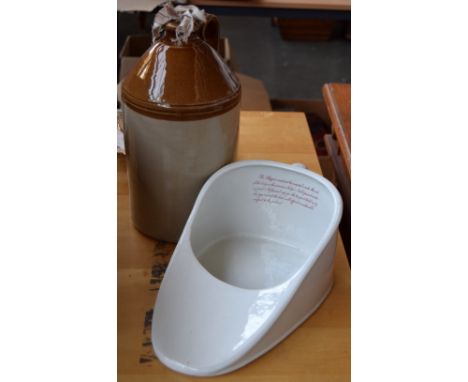 An early 20th century ceramic slipper bed pan and printed instructions under the glaze, 'The Slipper must not be inserted und