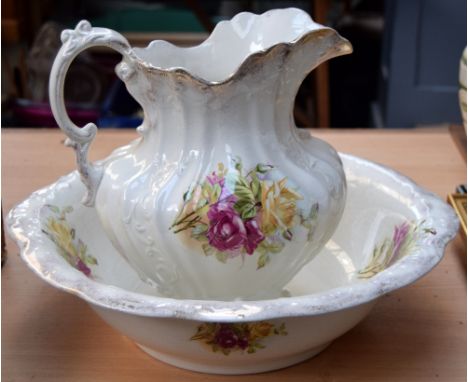 A ceramic water pitcher and bowl in floral pattern