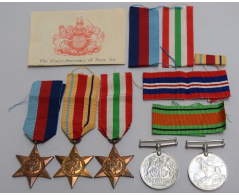 A collection of WWII campaign medals: The 1939-1945 Star, the Africa Star, the Italy Star, the Defence Medal and the  War Med