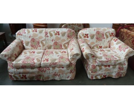 A two piece suite of a sofa and armchair upholstered in floral fabric