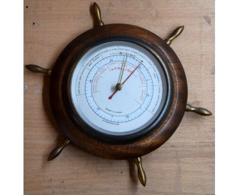 A Short and Mason wooden barometer in the form of a ship's wheel