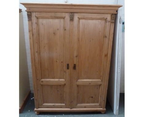 A vintage pine wardrobe with leaf scroll decoration, two doors and hanging space 60 x 127 x 192cmH