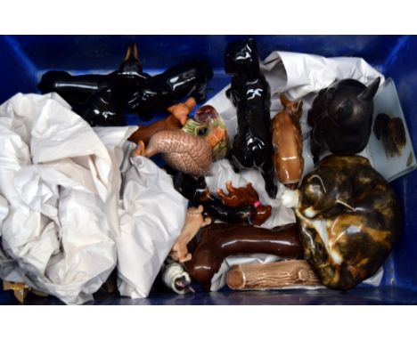 A collection of ceramic animal figurines, mostly of dachshunds, together with a number of Wade pieces and a Mike Hinton Winst