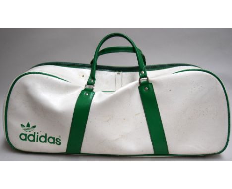 A vintage green and white Adidas sports holdall/racket bag, with a BP International Tennis Fellowship badge