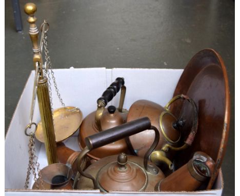 A collection of brass and copper items, including kettles, jugs, a large plate and a set of scales