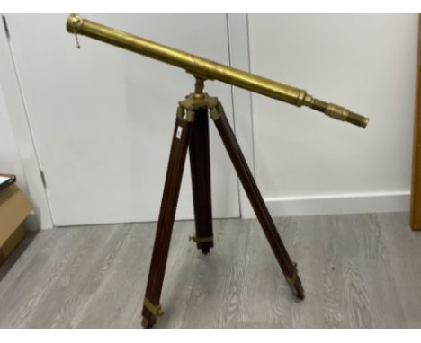Large brass telescope on wooden tripod stand