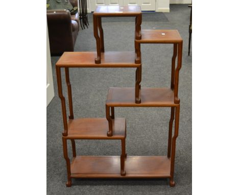 An Oriental hardwood open display rack, ladder rack shelving c.1970