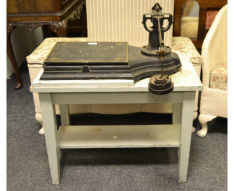 An early-20th century set of weighing scales on a rectangular table