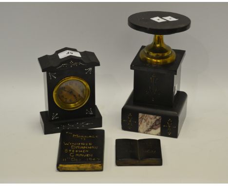 A mid-20th century Belge Noir carriage clock; a conforming garniture; a mid-20th century ebony desk weight in the form of a b