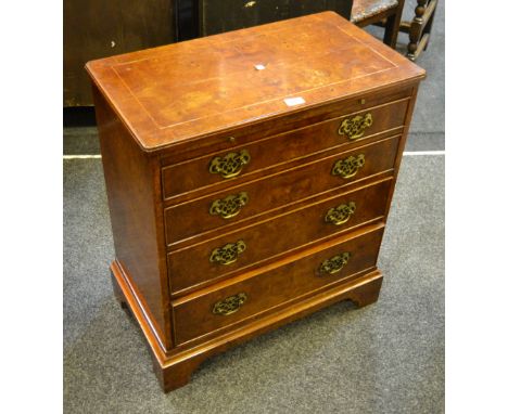 A George II style walnut bachelor's chest, quarter-veneered top above four long graduated cockbeaded drawers, pierced brass b