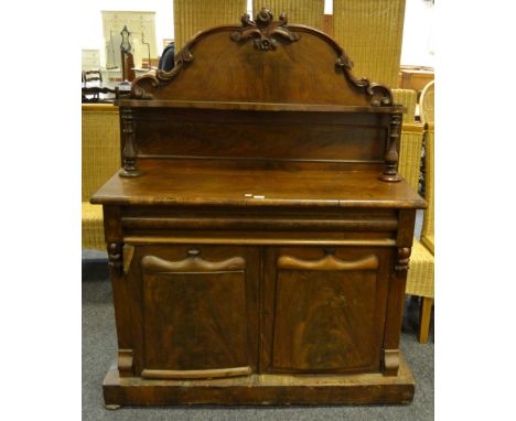 A Victorian mahogany chiffonier, the superstructure with shaped scrolling acanthus crest, serpentine-shaped shelf, one long b