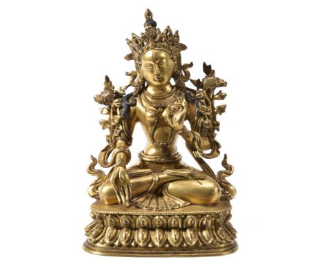 A Sino-Tibetan gilt-bronze figure of Tara, seated on a double lotus throne, hands in varada and vitarka mudra, a chrysanthemu