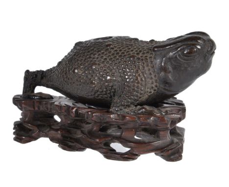 A Chinese bronze mythical three-legged water dropper, Ming-early Qing Dynasty, chánchú (蟾蜍), 11.2cm long, on fitted craved wo