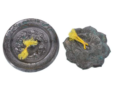 Two Chinese bronze mirrors, Han Dynasty or later, one with the central knop surrounded by mythical beasts, 13.3cm diameter an