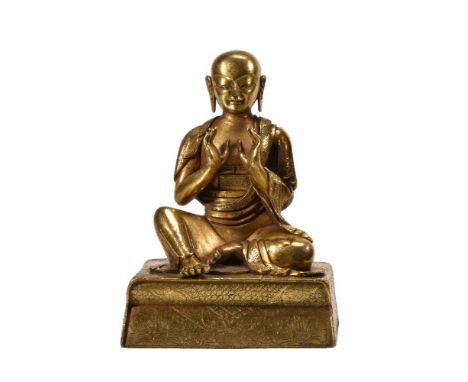A Sino-Tibetan gilt-bronze Louhan, Qing Dynasty, seated with hands held up and on incised rectangular base, 15cm high x 10.5c