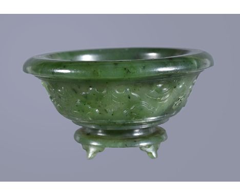 A small Chinese spinach jade bowl, probably late Qing Dynasty or Republican Period, the exterior craved with stylised foliage