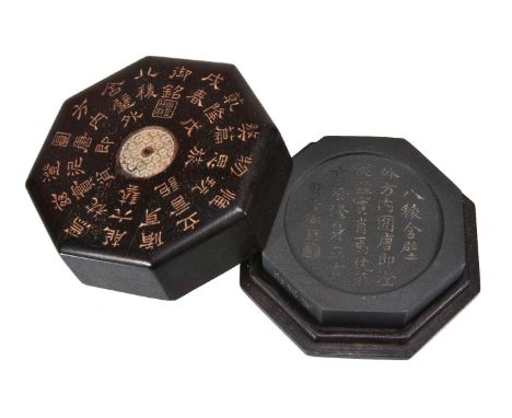 A Chinese hardwood octagonal box and cover with ink stone, after a Tang original, inlaid with a jade disc to the centre, with